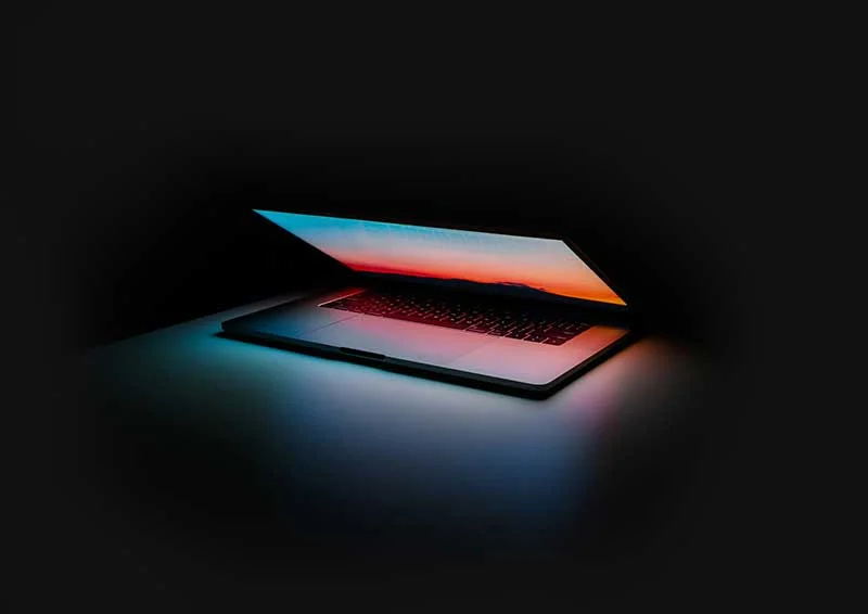 Open laptop displaying a colorful sunset